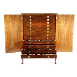 ALFRED DUNHILL. A RARE COLLECTION OF PIPES C.1974-76 the Queen Anne style walnut cabinet with a