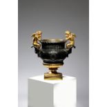 A GILT BRONZE 'DUVAL' URN 20TH CENTURY the squat baluster body applied with crested roundels beneath