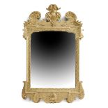 A GEORGE II GILTWOOD WALL MIRROR C.1730-40 the shaped rectangular plate within a leaf and scroll