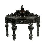 AN ANGLO-INDIAN EBONY BUDDHIST 'MOONSTONE' CONSOLE TABLE CEYLON, MID-19TH CENTURY of demi-lune form,