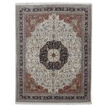 AN INDIAN CARPET MODERN the cream field of scrolling vines centred by a deep terracotta medallion