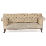 A VICTORIAN TWO SEATER SOFA IN THE MANNER OF HOWARD & SONS, LATE 19TH CENTURY with scroll arms and