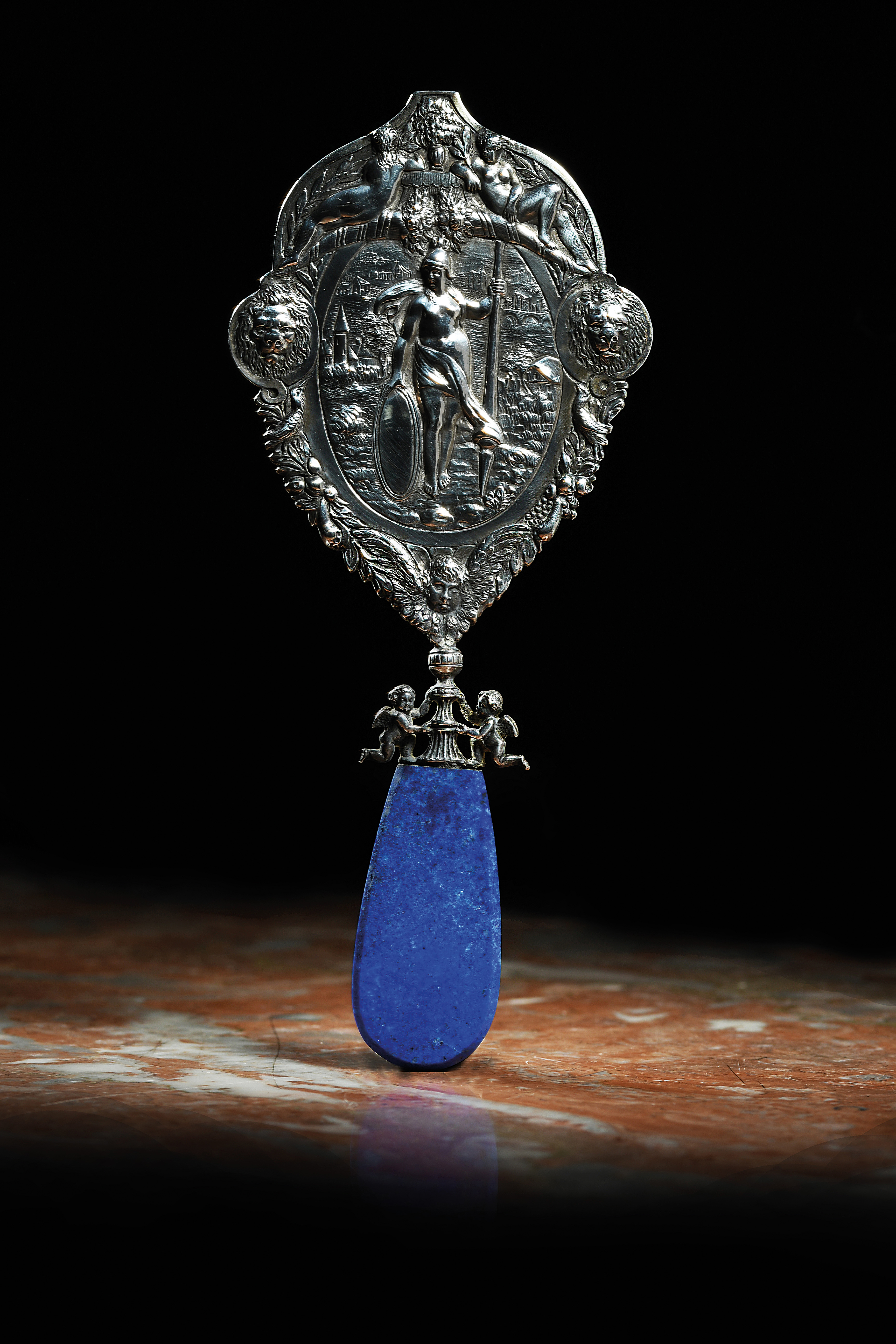 A LAPIS LAZULI HANDLED SILVER MIRROR UNMARKED, PROBABLY 19TH CENTURY of shaped oval form, with a