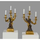 A PAIR OF FRENCH ORMOLU AND PATINATED BRONZE FIGURAL CANDELABRA AFTER THE MODEL BY PHILLIPPE