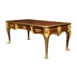 A FRENCH KINGWOOD AND ORMOLU MOUNTED BUREAU PLAT IN REGENCE STYLE AFTER THE MODEL BY CHARLES