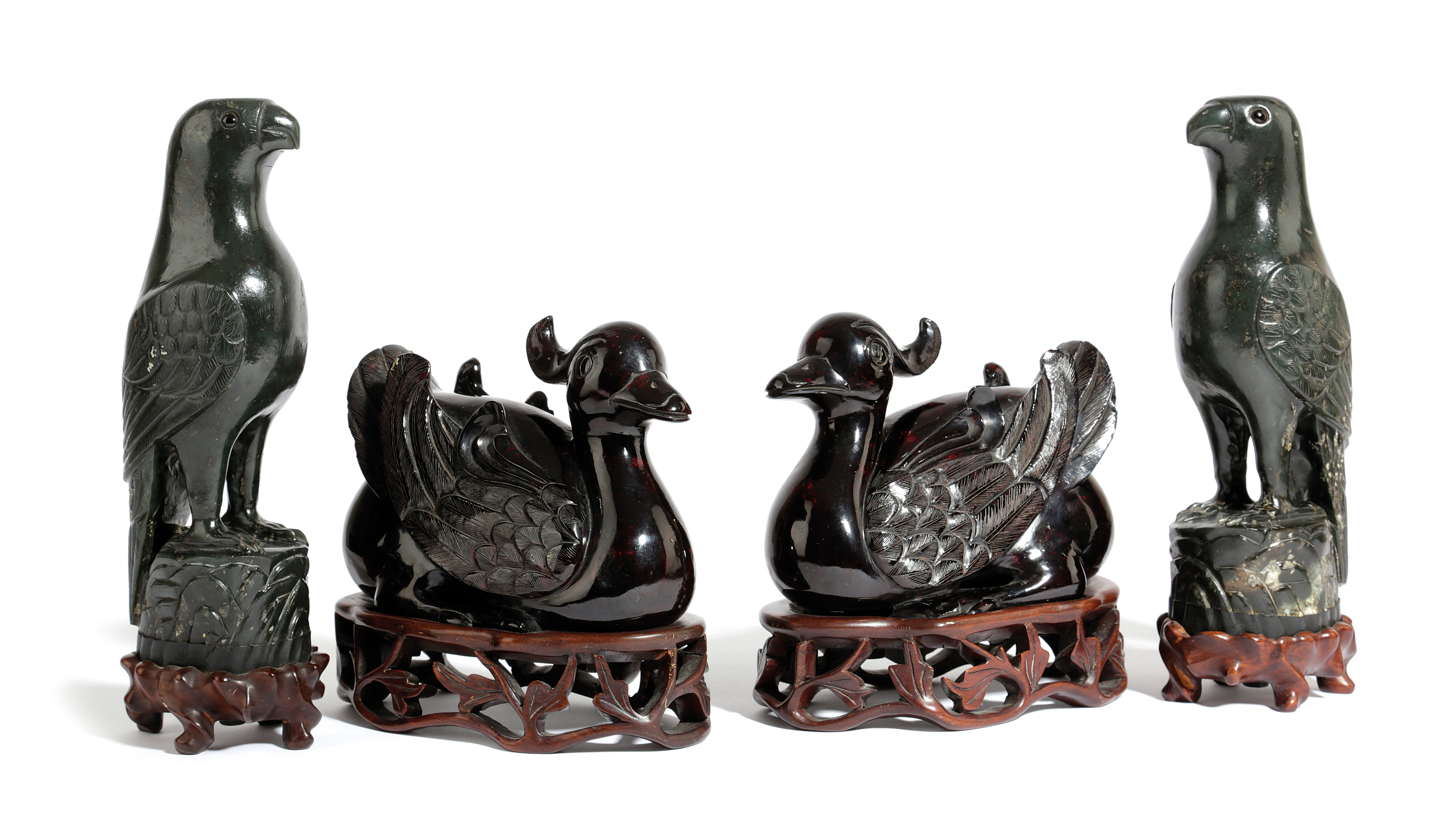 A PAIR OF CHINESE AMBER STYLE TUFTED DUCKS 20TH CENTURY modelled squatting on the ground, on pierced