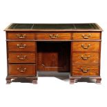 A MAHOGANY KNEEHOLE DESK IN GEORGE III STYLE, 18TH CENTURY ELEMENTS BUT LATER ADAPTED the moulded