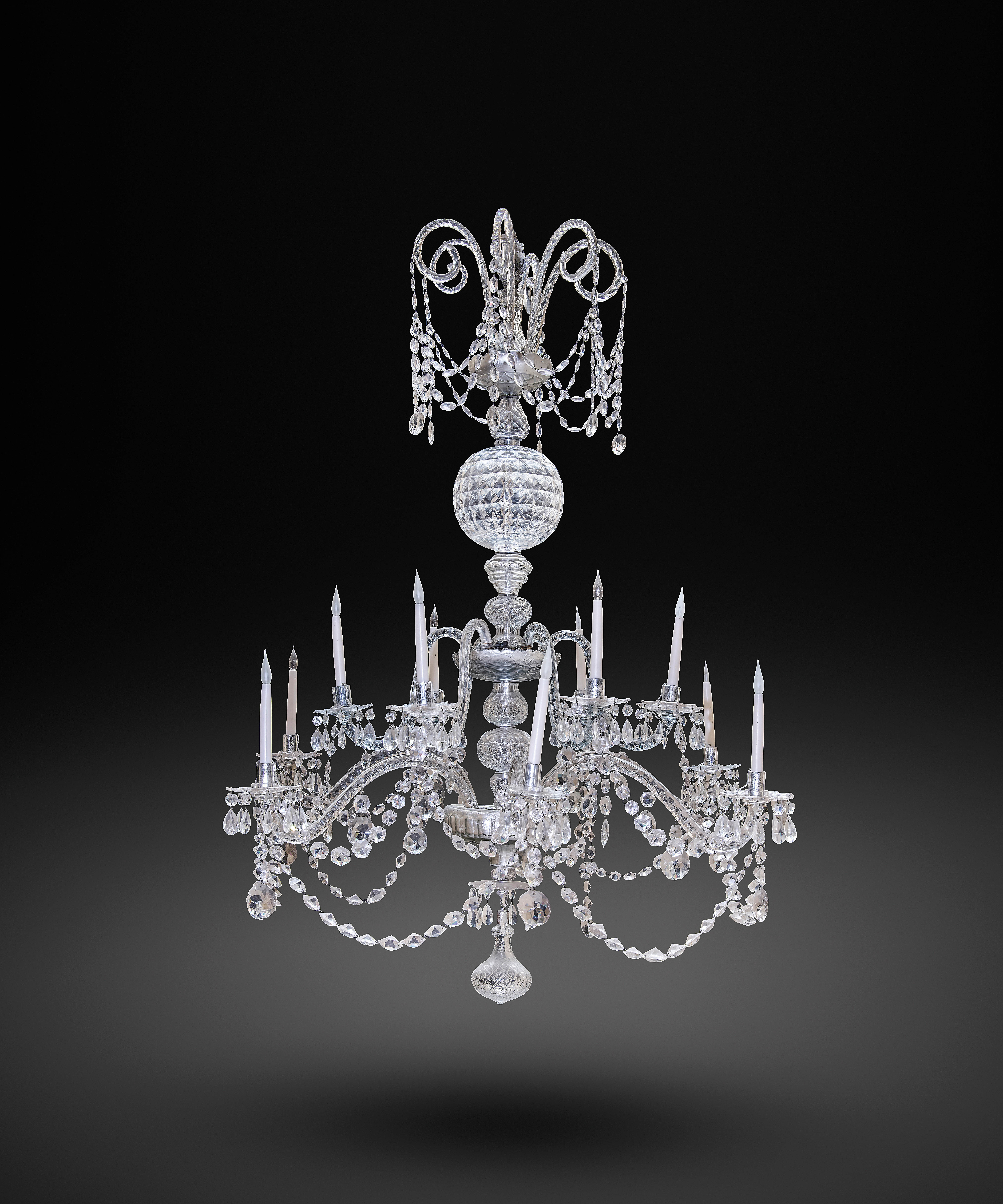 A LARGE CUT-GLASS TWELVE LIGHT CHANDELIER IN GEORGE III STYLE, 19TH CENTURY the faceted ovoid
