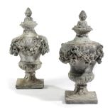 A PAIR OF GEORGE II LEAD FINIALS C.1730-40 each of campana urn shape decorated with swags of fruit