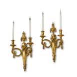A PAIR OF FRENCH ORMOLU TWIN-LIGHT WALL APPLIQUES IN LOUIS XVI STYLE, AFTER A DESIGN BY QUENTIN­-