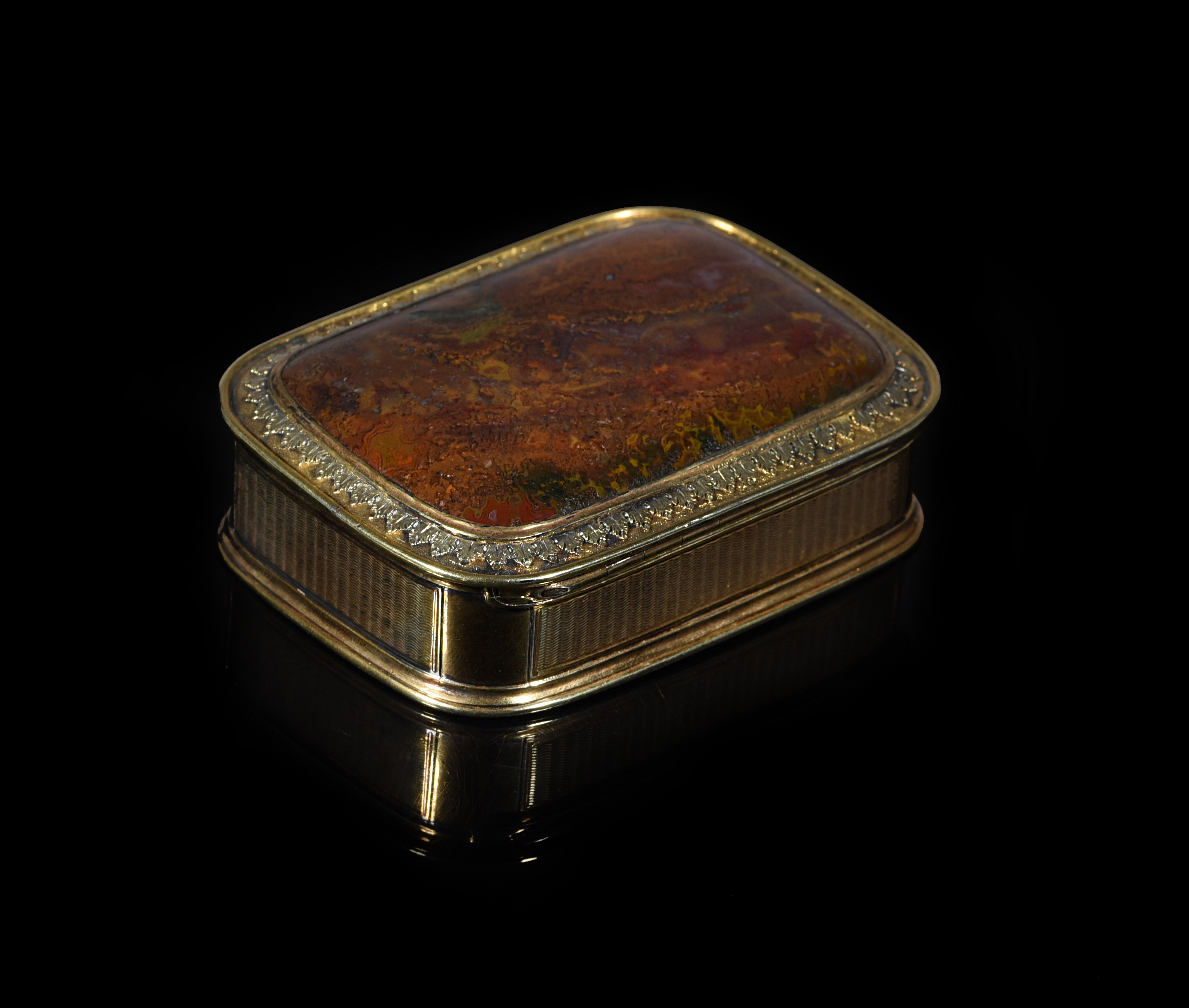 A SILVER-GILT MOUNTED AGATE SNUFF BOX UNMARKED, C.1830 of rounded rectangular form, the hinged cover