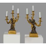 A PAIR OF FRENCH ORMOLU AND PATINATED BRONZE FIGURAL CANDELABRA AFTER THE MODEL BY PHILLIPPE