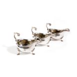 A SET OF THREE SILVER SAUCE BOATS BY SEBASTIAN GARRARD, LONDON, 1913 of oval form, with gadroon