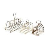 THREE TOAST RACKS including: a George III silver seven bar example by Samuel & George Whitford,