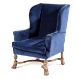 AN EDWARDIAN WALNUT WING ARMCHAIR BY HOWARD & SONS, IN WILLIAM AND MARY STYLE, EARLY 20TH CENTURY