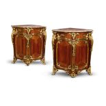 A PAIR OF LOUIS XV AMARANTH AND BOIS SATINE ORMOLU MOUNTED ENCOIGNURES ATTRIBUTED TO JEAN-PIERRE