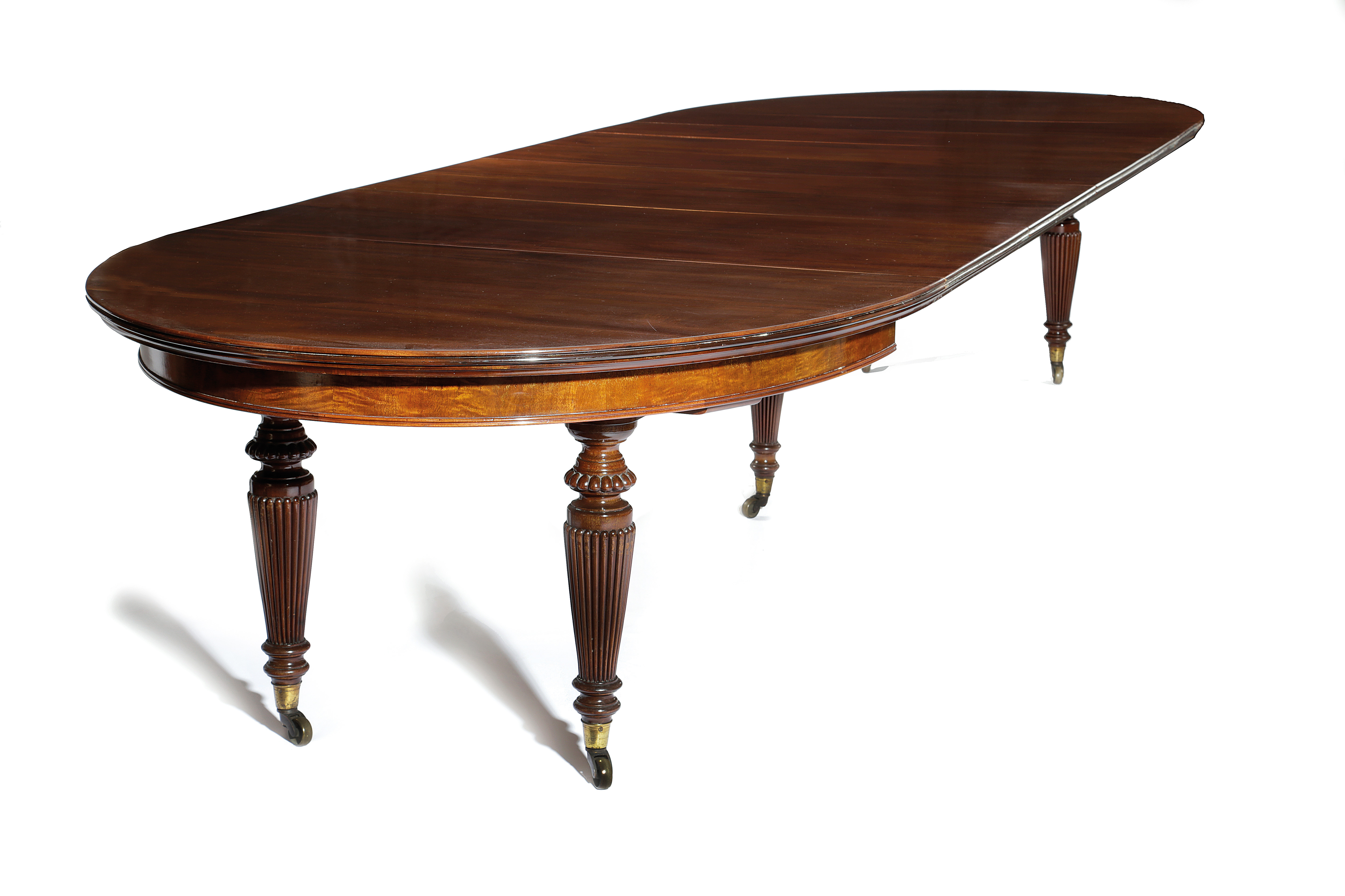 A VICTORIAN MAHOGANY DINING TABLE C.1870-80 the top with a reeded edge with rounded ends extending