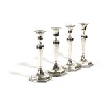 A SET OF FOUR GEORGE V PRESENTATION SILVER CANDLESTICKS BY HAWKSWORTH, EYRE AND CO., SHEFFIELD, 1931