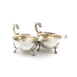 A pair of George II silver sauce boats, maker's mark W?, London 1753, oval form, wavy-edge border,
