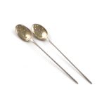 Two 18th century silver mote spoons, unmarked, the oval bowls with plain rat-tails and gilded bowls,