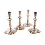 A set of four George II silver candlesticks, by James Gould, London 1739, knopped baluster stems,