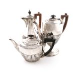 A Victorian silver coffee pot, by Carrington and Co., London 1886, oval form, part-fluted