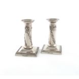 A pair of Edwardian silver dwarf candlesticks, by Mappin and Webb, London 1903, the columns with