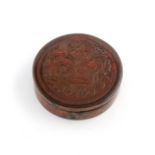 A 19th century red lacquer composition snuff box, circa 1820-40, circular form, the body and base