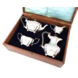 A four-piece silver tea set, by J. Gloster and Co., Birmingham 1911, shaped oblong bellied form,