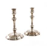 A pair of George II cast silver candlesticks, by James Gould, London 1732, knopped columns, spool-