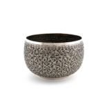 A Burmese metalware rice bowl, circular form, embossed with foliate decoration, the underside with a