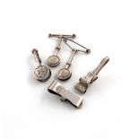 A collection of five silver napkin clips, various dates and makers comprising: three of circular