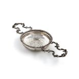 A George III silver two-handled lemon strainer, maker's mark partially worn, London 1760, circular
