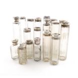 A collection of silver-mounted dressing table jars and bottles, various dates and makers, plain