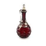 A Victorian silver-gilt mounted squeeze-action red glass decanter/claret jug, by Frederick