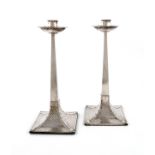 A pair of Edwardian silver Arts and Crafts candlesticks, by James Dixon and Sons, Sheffield 1906,