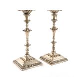 A pair of George III cast silver candlesticks, by Ebenezer Coker, London 1771, tapering knopped