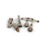 A collection of five silver napkin clips, various dates and makers comprising: two of circular form,