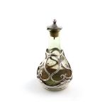 By Omar Ramsden & Alwyn Carr, an Arts and Crafts silver-mounted glass oil bottle, London 1916,