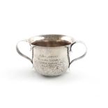 By Moss Morris, an Arts and Crafts presentation silver porringer, London 1905, circular form, scroll