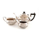 A three-piece silver tea set, by Gilbert & Co, Birmingham 1919, oval form, part-fluted decoration,