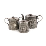 A three-piece Indian silver tea set, Cutch, circa 1900-1920, tapering circular form, chased