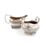 A George III silver cream jug, makers mark worn, London 1818, oval form, part-fluted decoration,