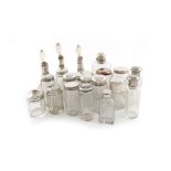 A collection of silver-mounted glass jars and scent bottles, various dates and makers, comprising: