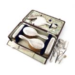 A collection of silver dressing table items, various dates and makers, comprising: a hand mirror,