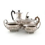 A four-piece Victorian silver tea set, by The Barnards, London 1898, oval bellied form, embossed