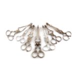 A collection of seven pairs of sugar nips, 18th and 19th century, conventional form, scroll arms,