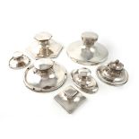 A collection of seven silver capstan inkwells, various dates and makers, comprising: a large capstan