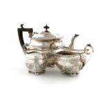 A late-Victorian three-piece silver tea set, by W. Aitken, Birmingham 1893, rounded rectangular