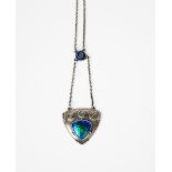 A Charles Horner silver and enamel pendant, shield shaped, cast in low relief and enamelled with a